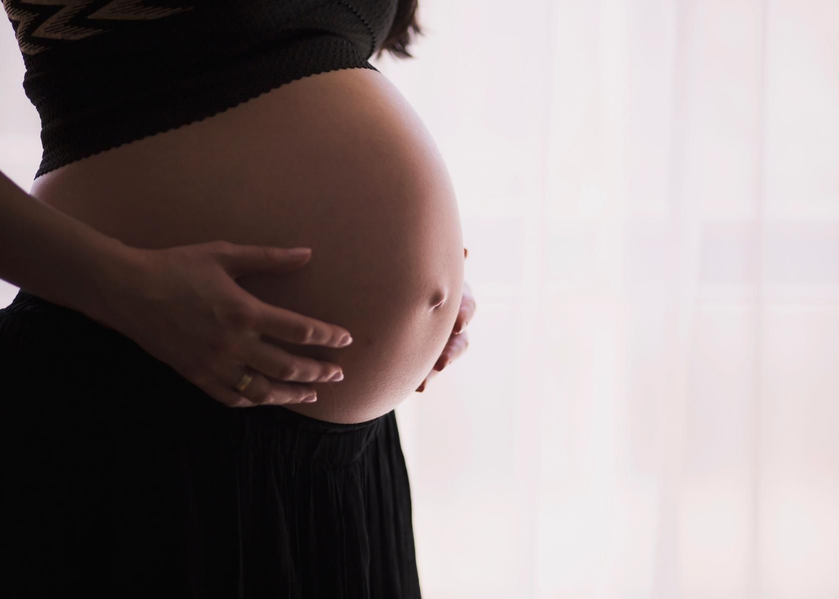 pregnant woman with hands on stomach