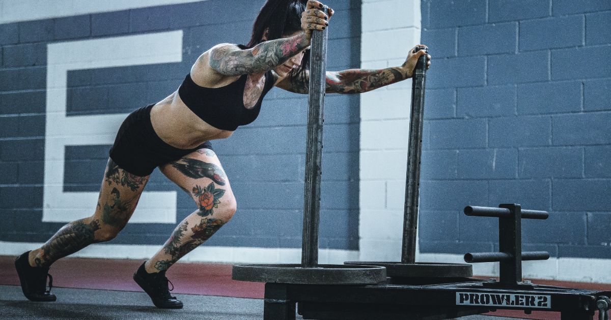woman pushing sled