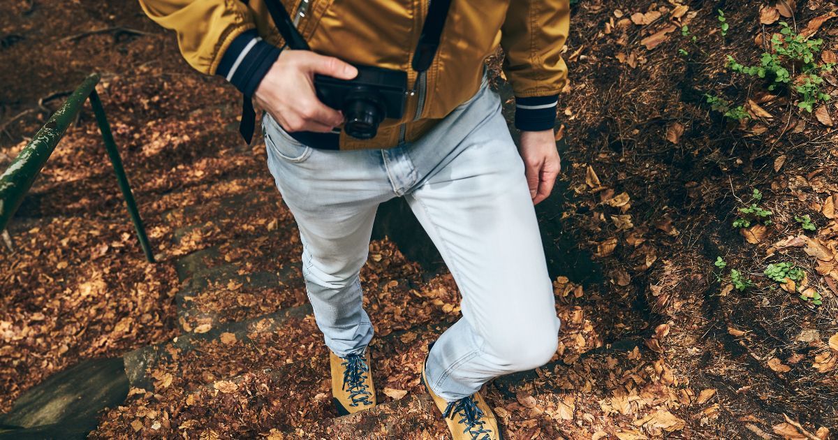 man carrying camera on hike