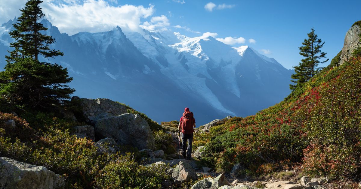 man hiking with mountains in the background