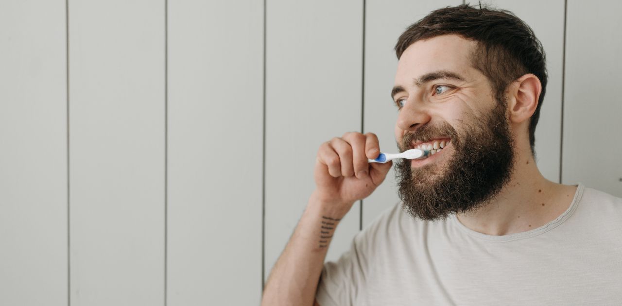 man brushing his teeth