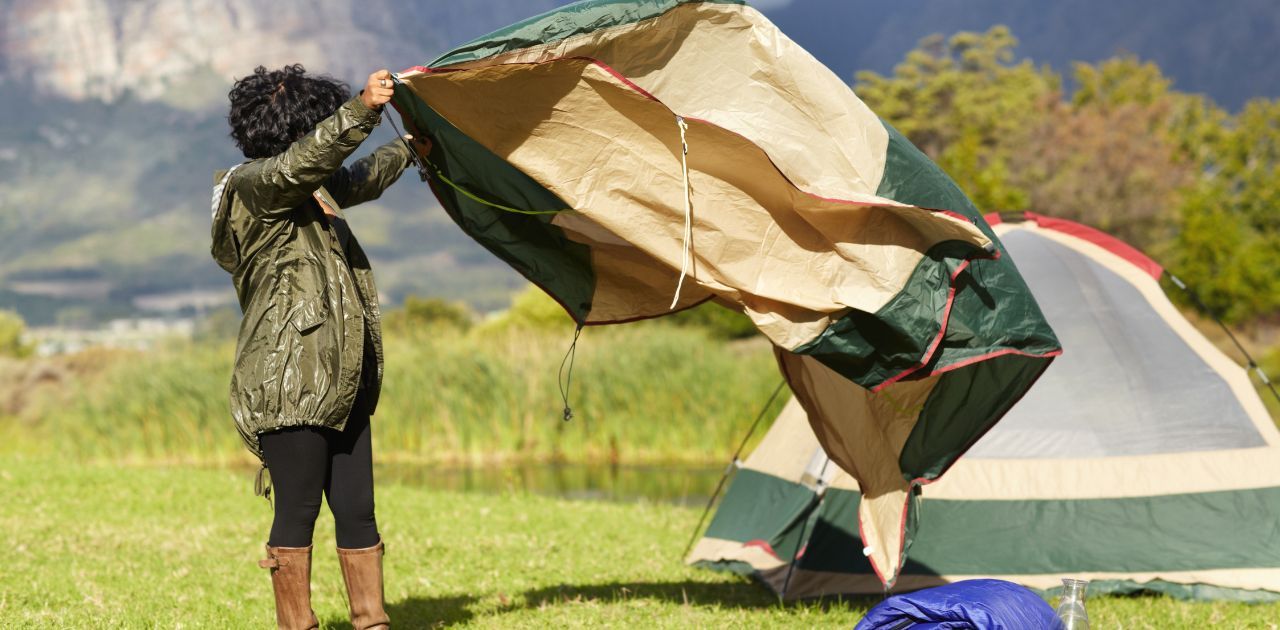 person laying out tent
