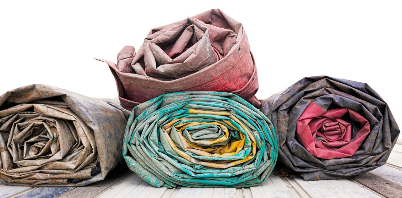 pile of rolled up tarps