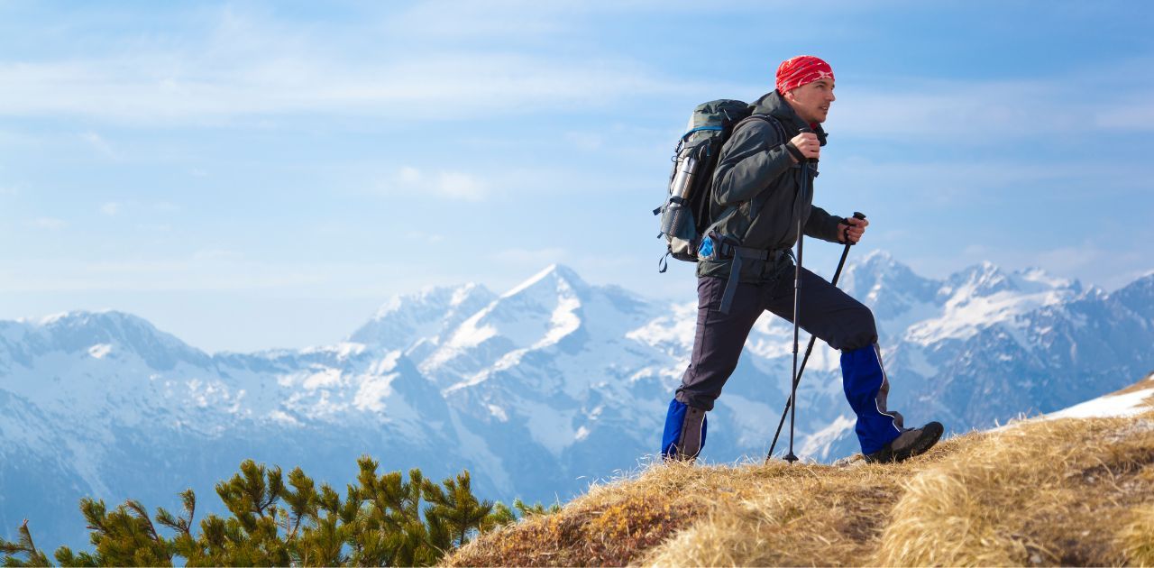 man hiking with mountains in the background