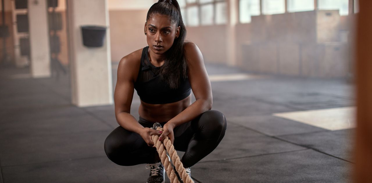 woman in squat resting after workout