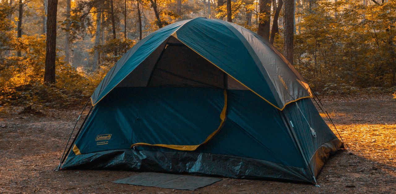 dome tent setup around trees