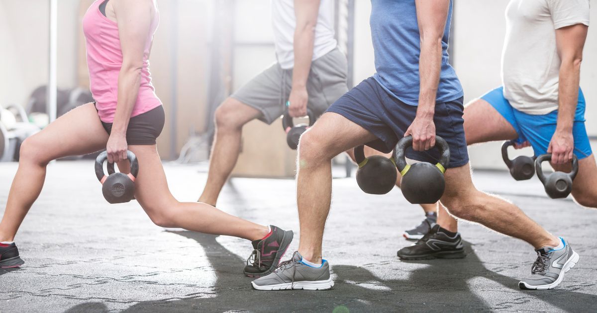 people working out doing lunges with kettlebells