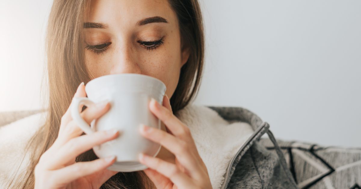 woman drinking from cup