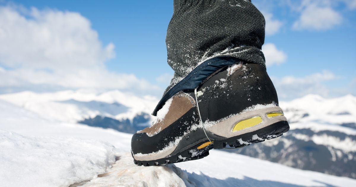 hiking boot against mountain backdrop