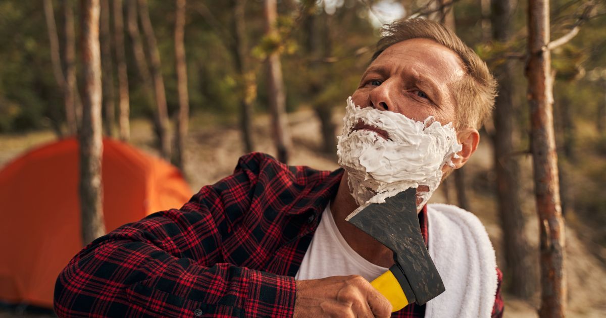 man shaving with hatchet