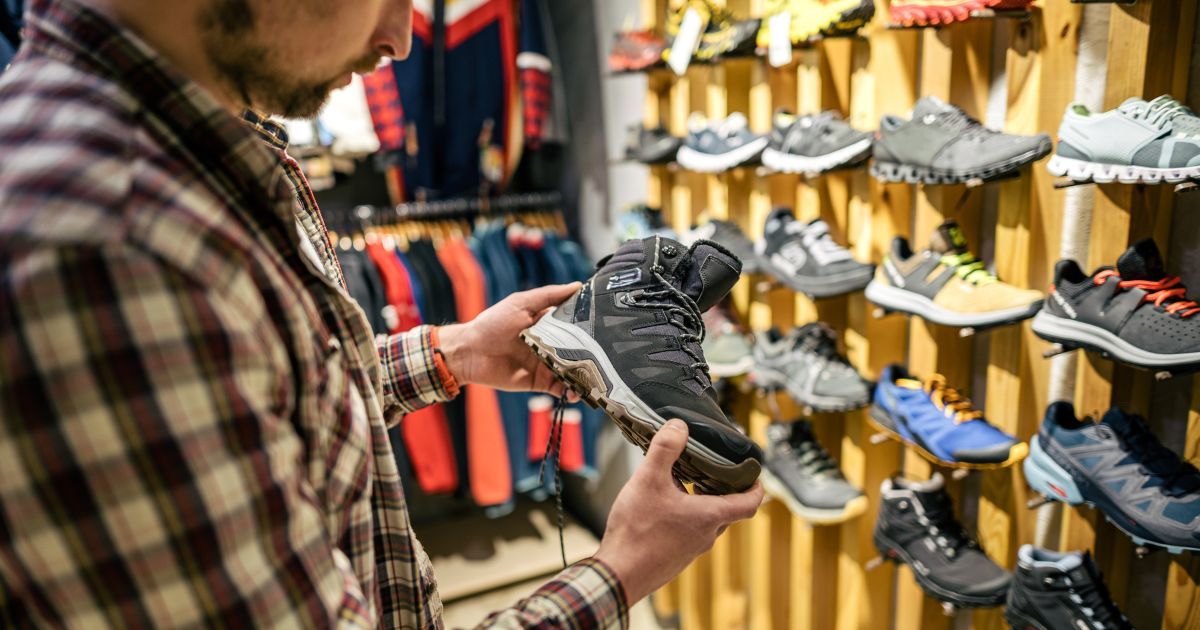 man holding hiking boot