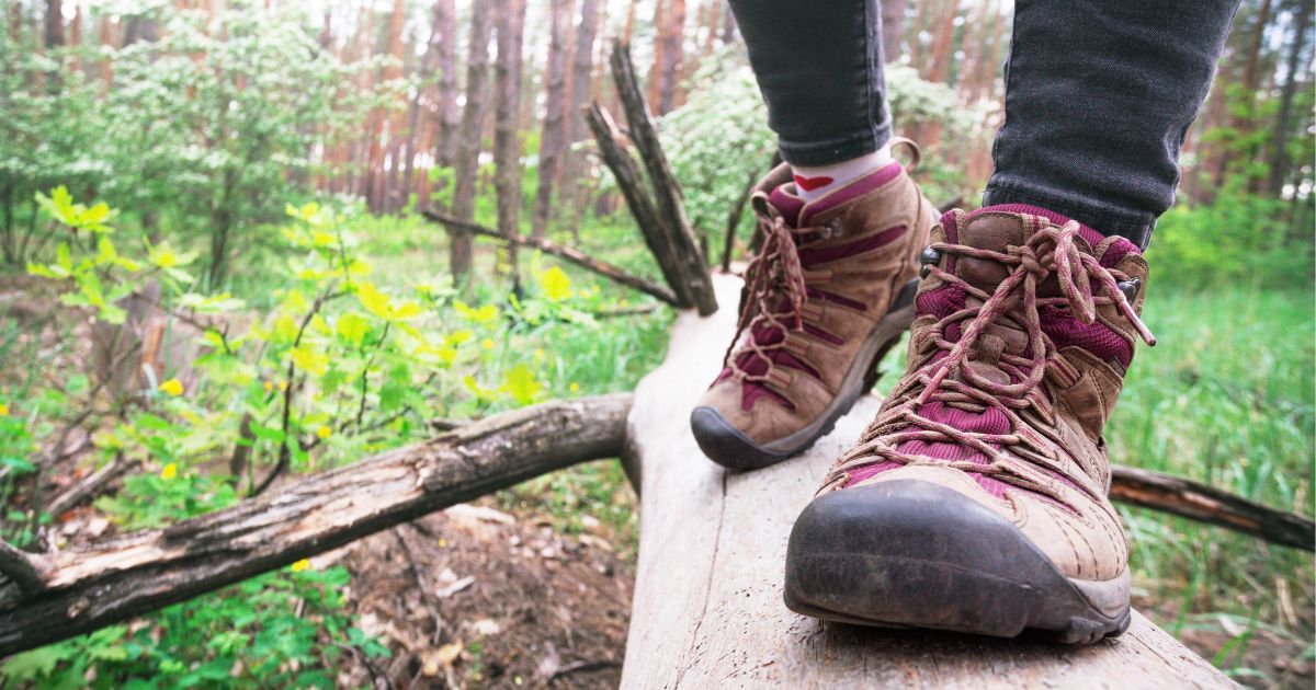 girl walking on log in mid height boots