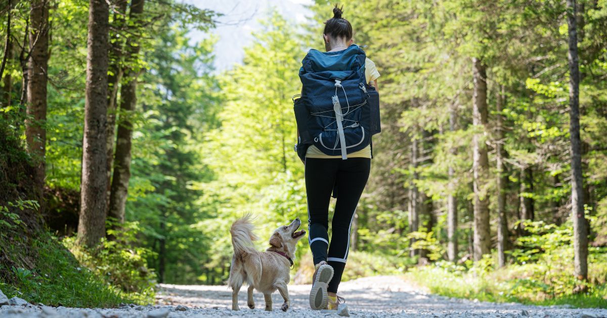 woman hiking with dog