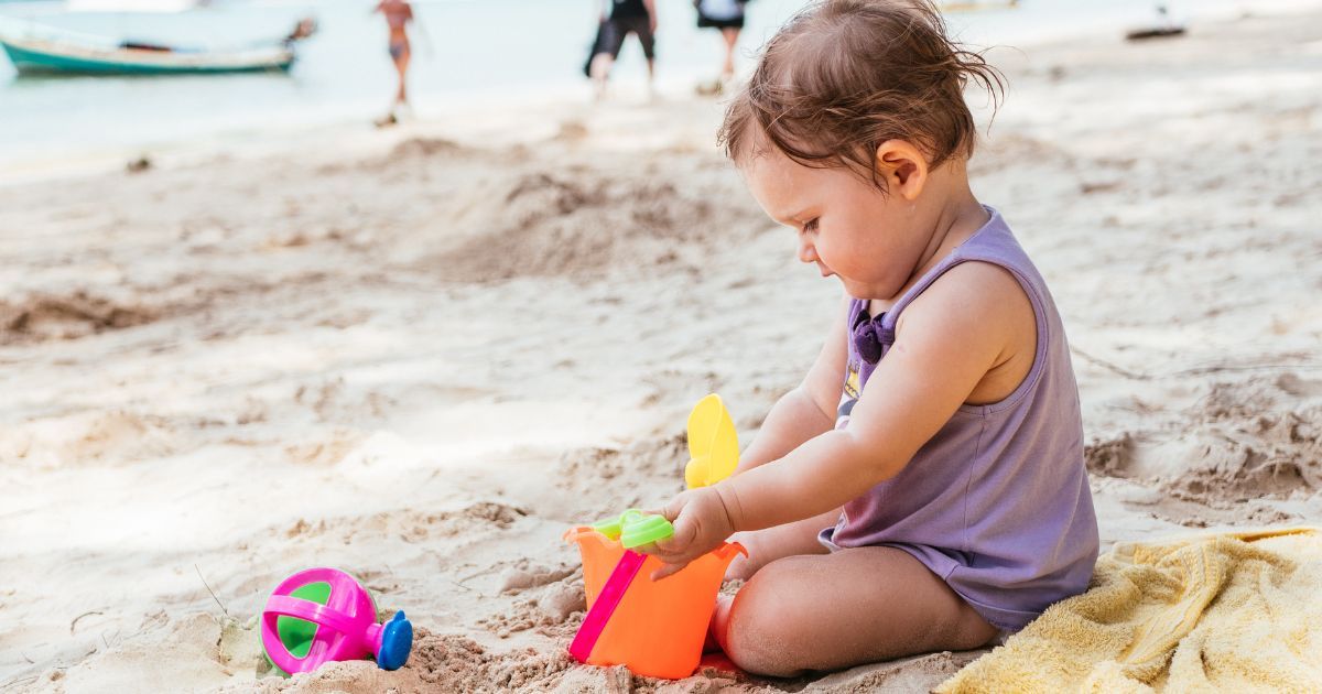 9 month old playing in sand