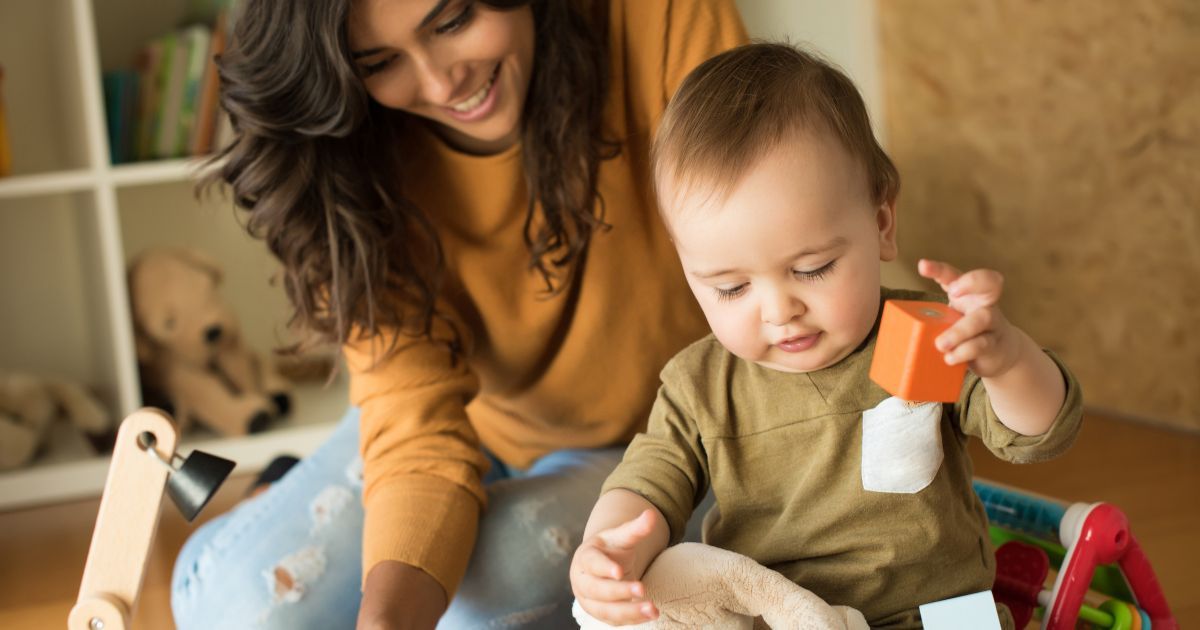 Mother and baby playing with toy