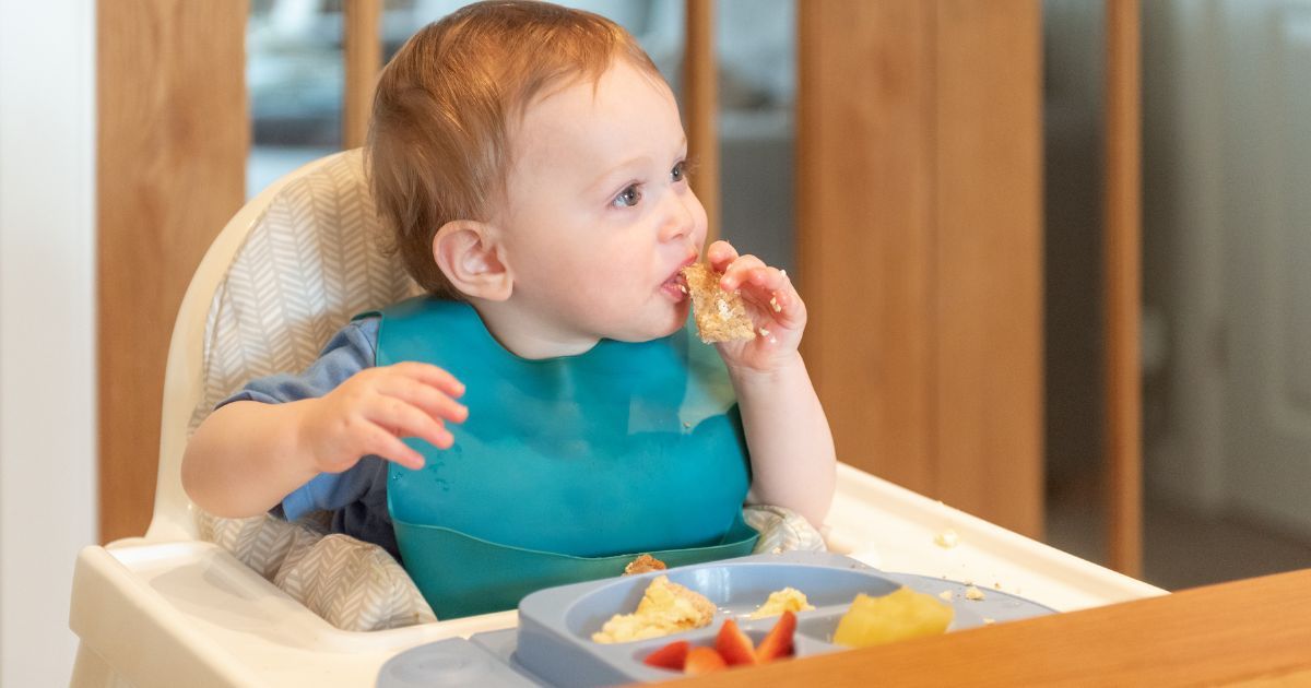 baby in high chair self feeding