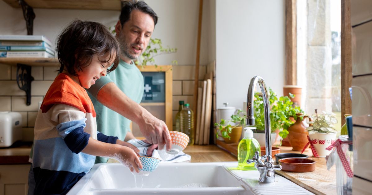 child helping clean dishes