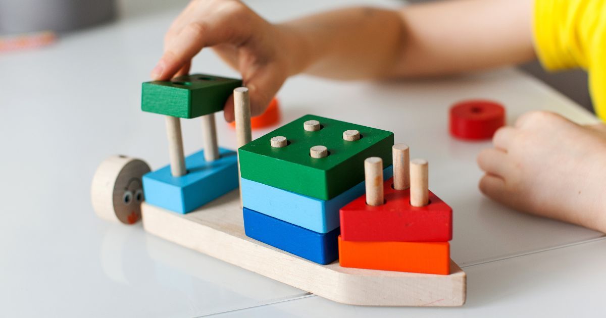 child playing with stacking toy