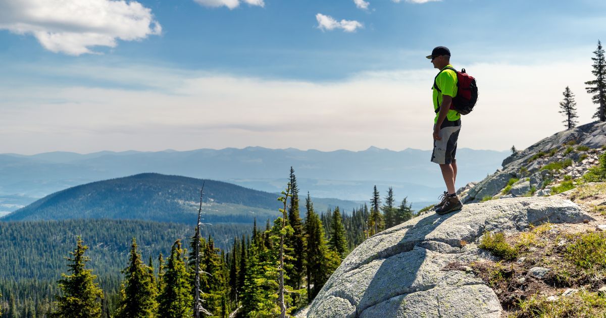 man overlooking a mountain view