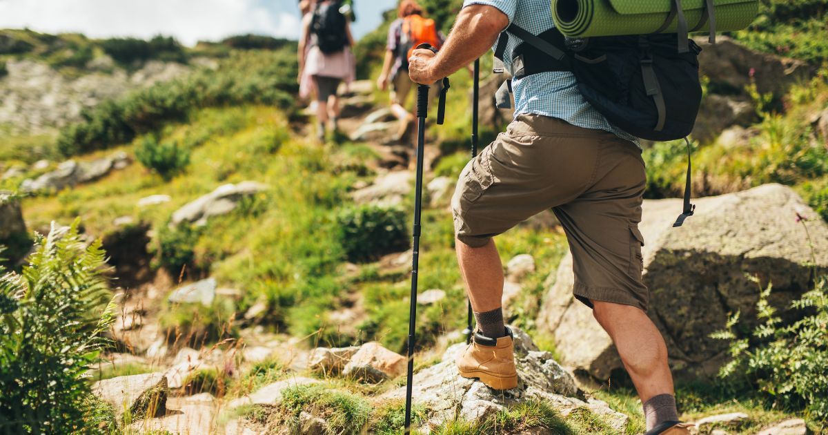 man hiking over rocks