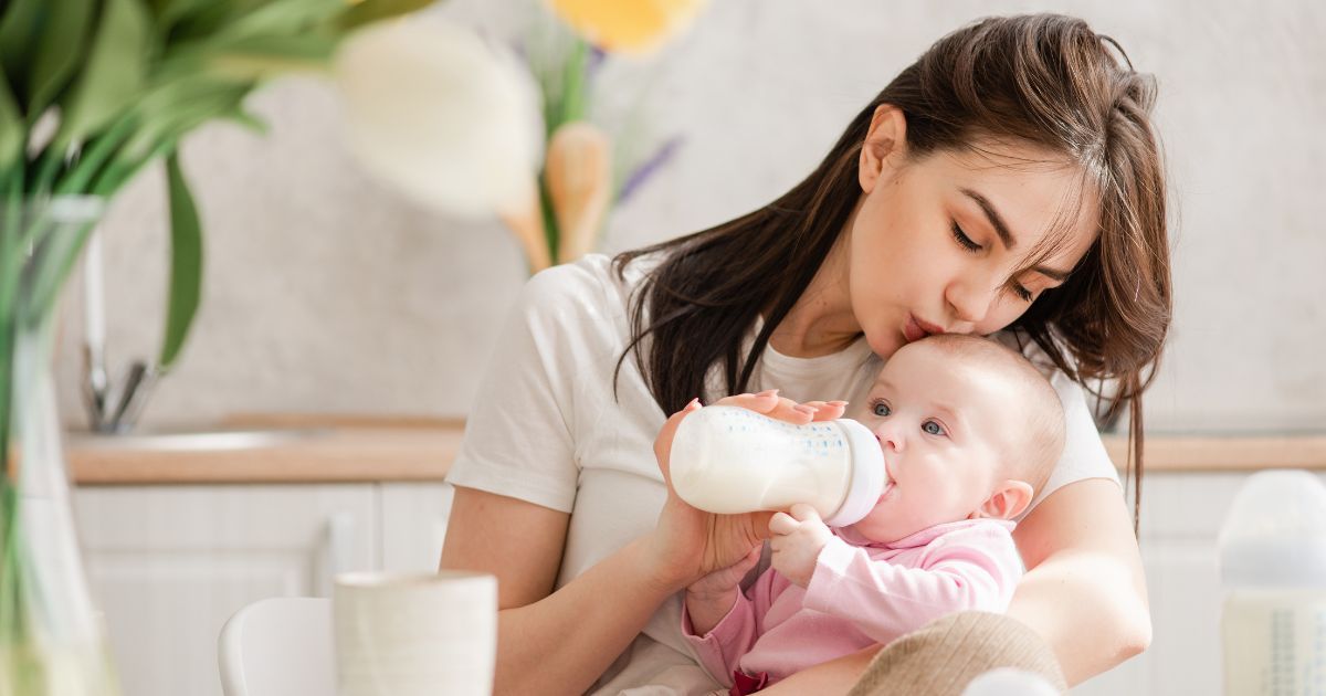mother feeding baby with bottle