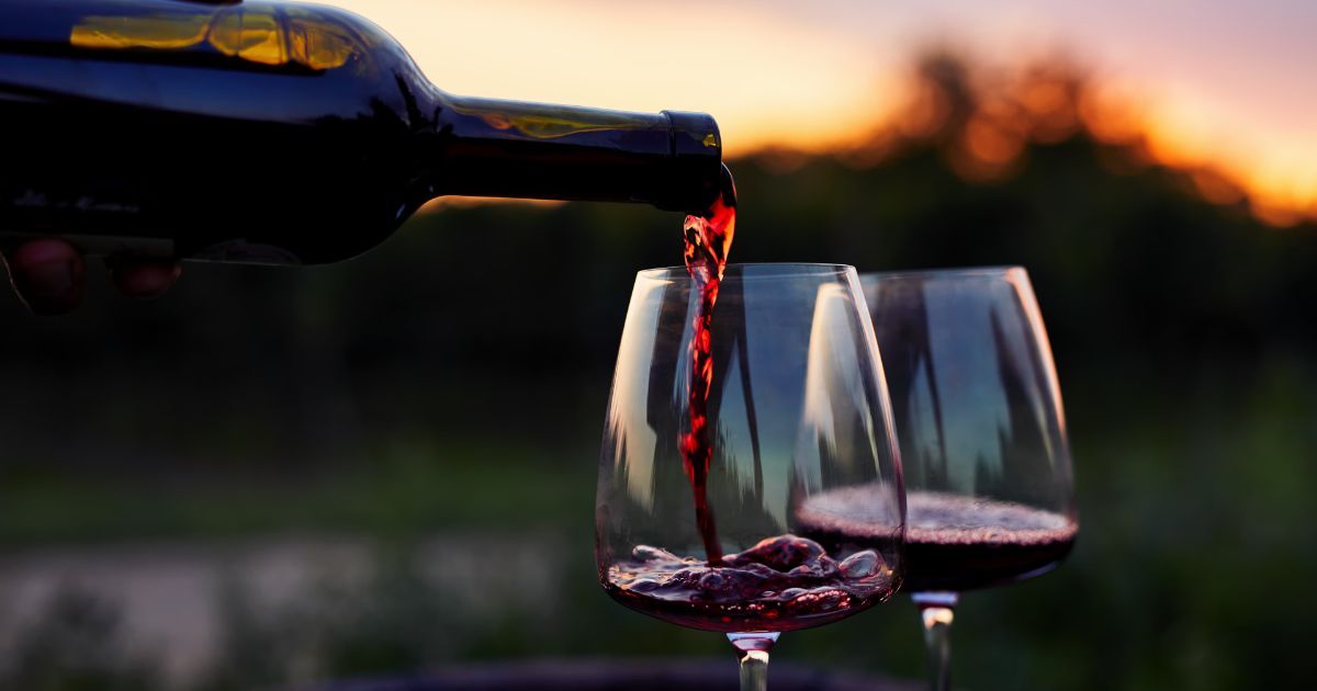 pouring red wine into glass