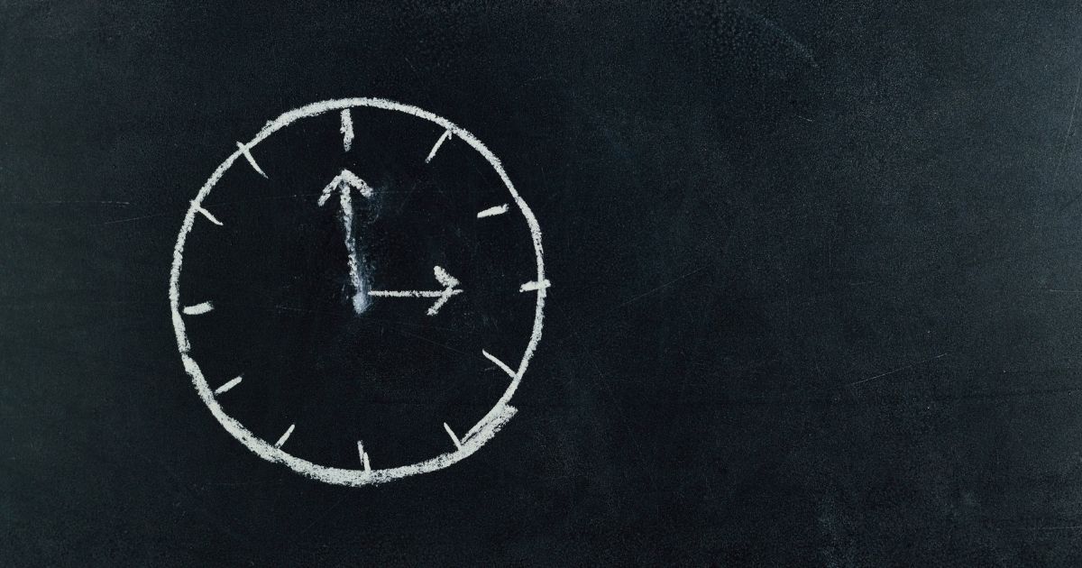 analog clock sketch on blackboard