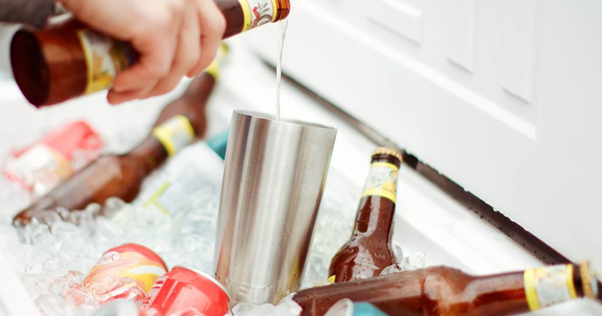 pouring beer into cup in yeti cooler