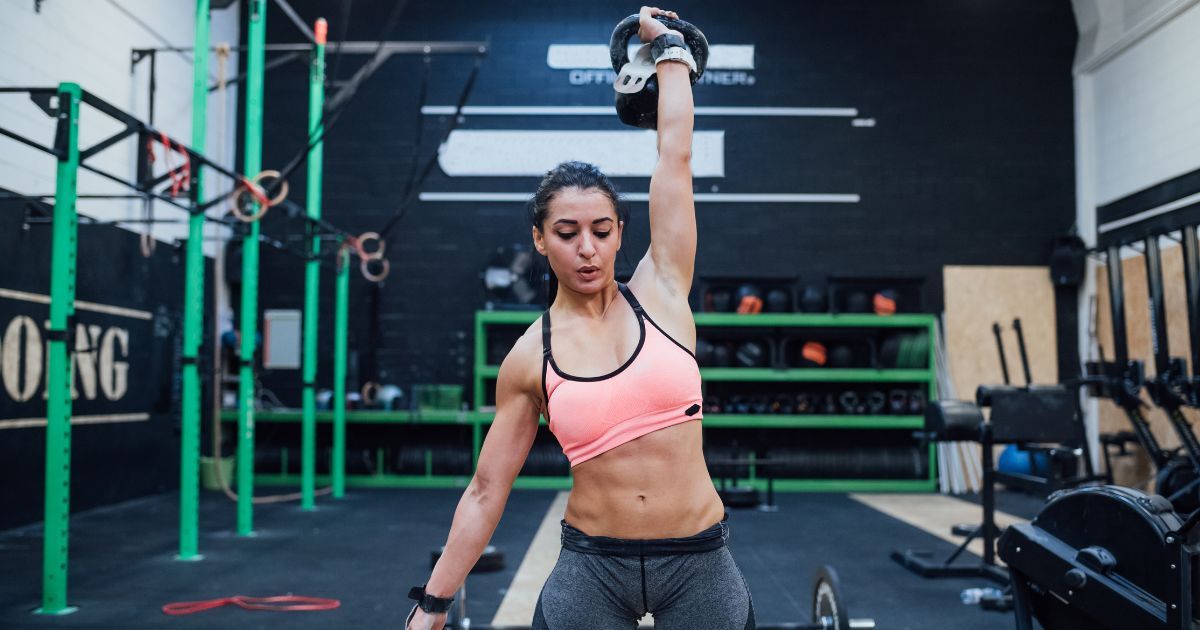 woman performing kettlebell snatch