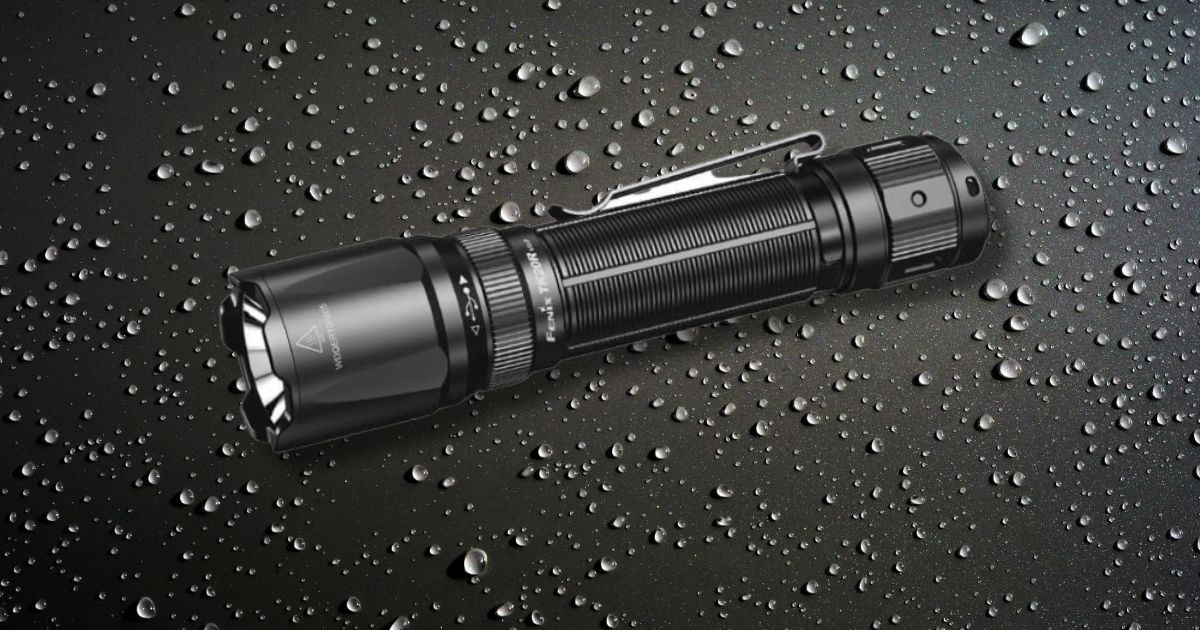 fenix flashlight on water droplet background
