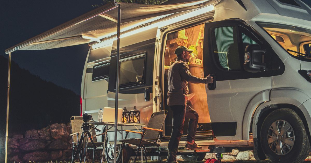 man standing by camping van