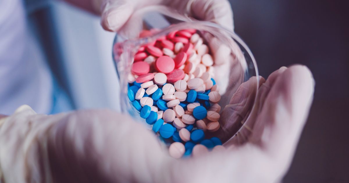 pharmacist pouring pills in hand