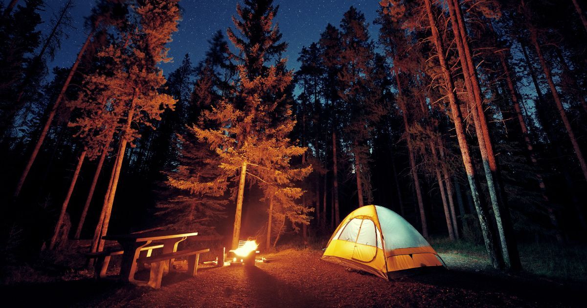 tent setup by fire at night