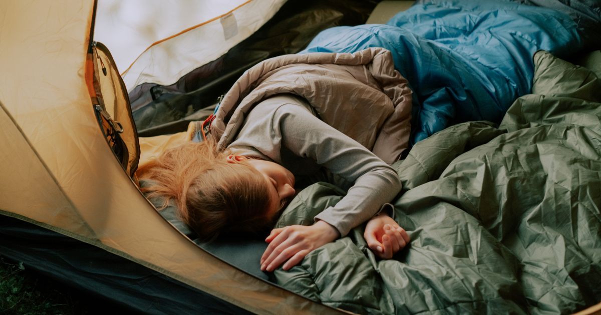 woman sleeping in tent