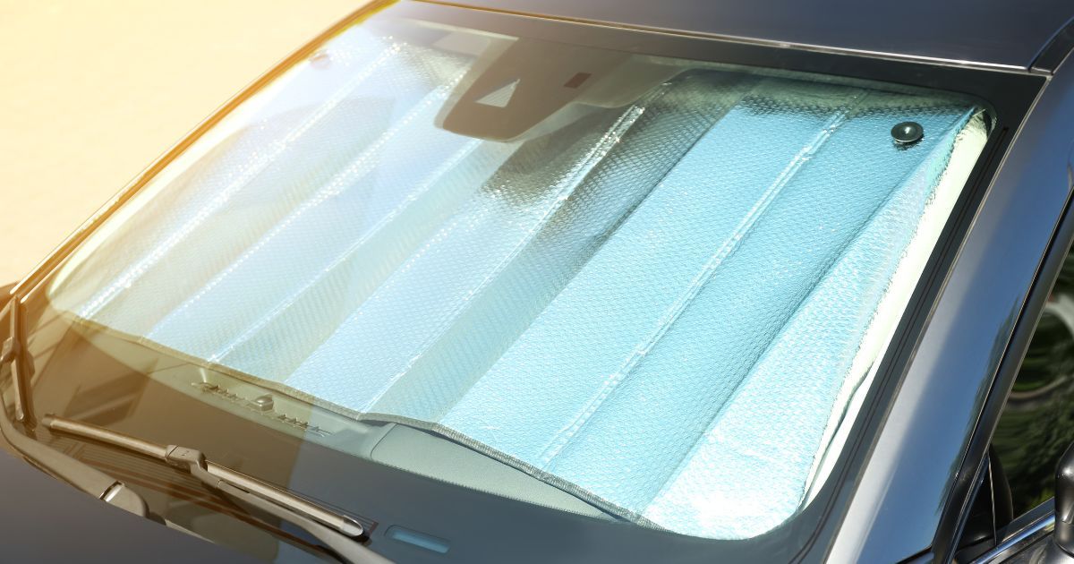 car with sunshade over windsheild