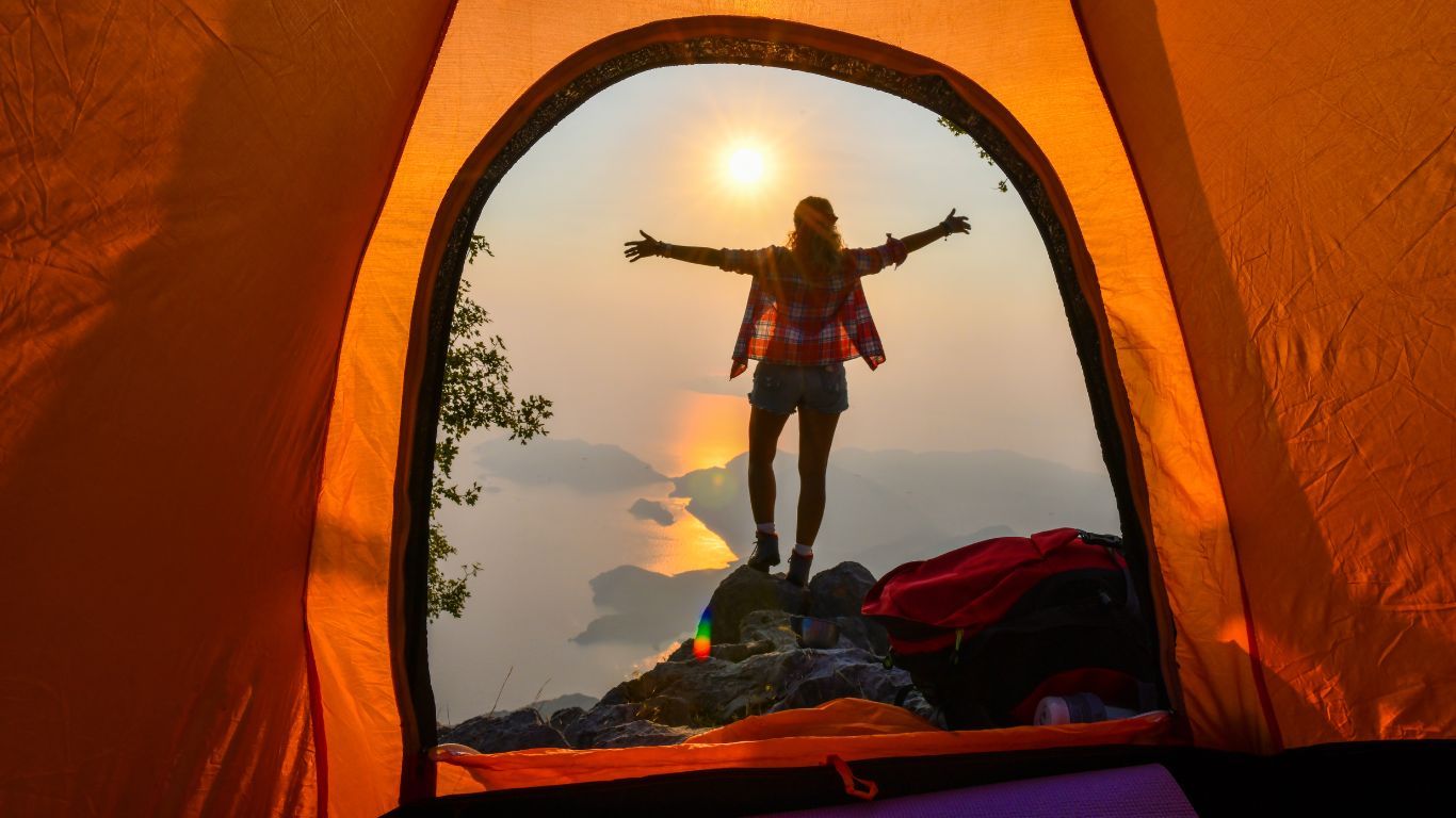 inside tent looking out at person