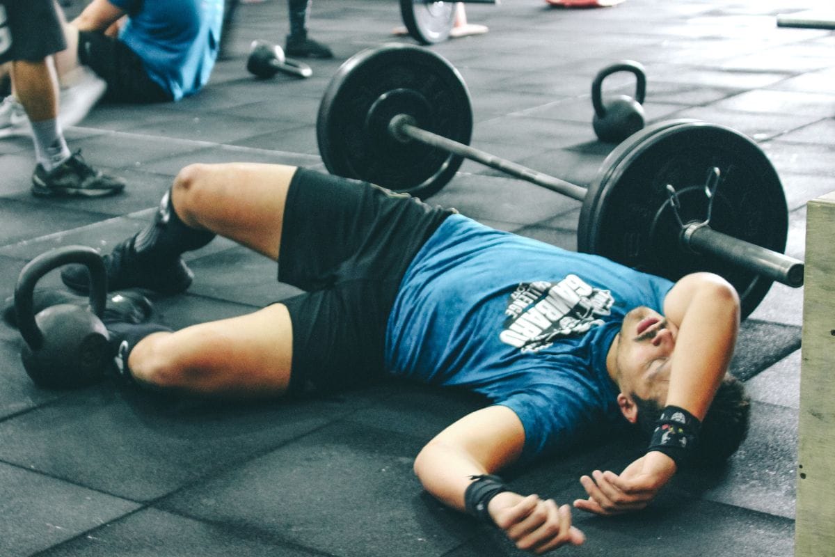 man lying on ground exhausted
