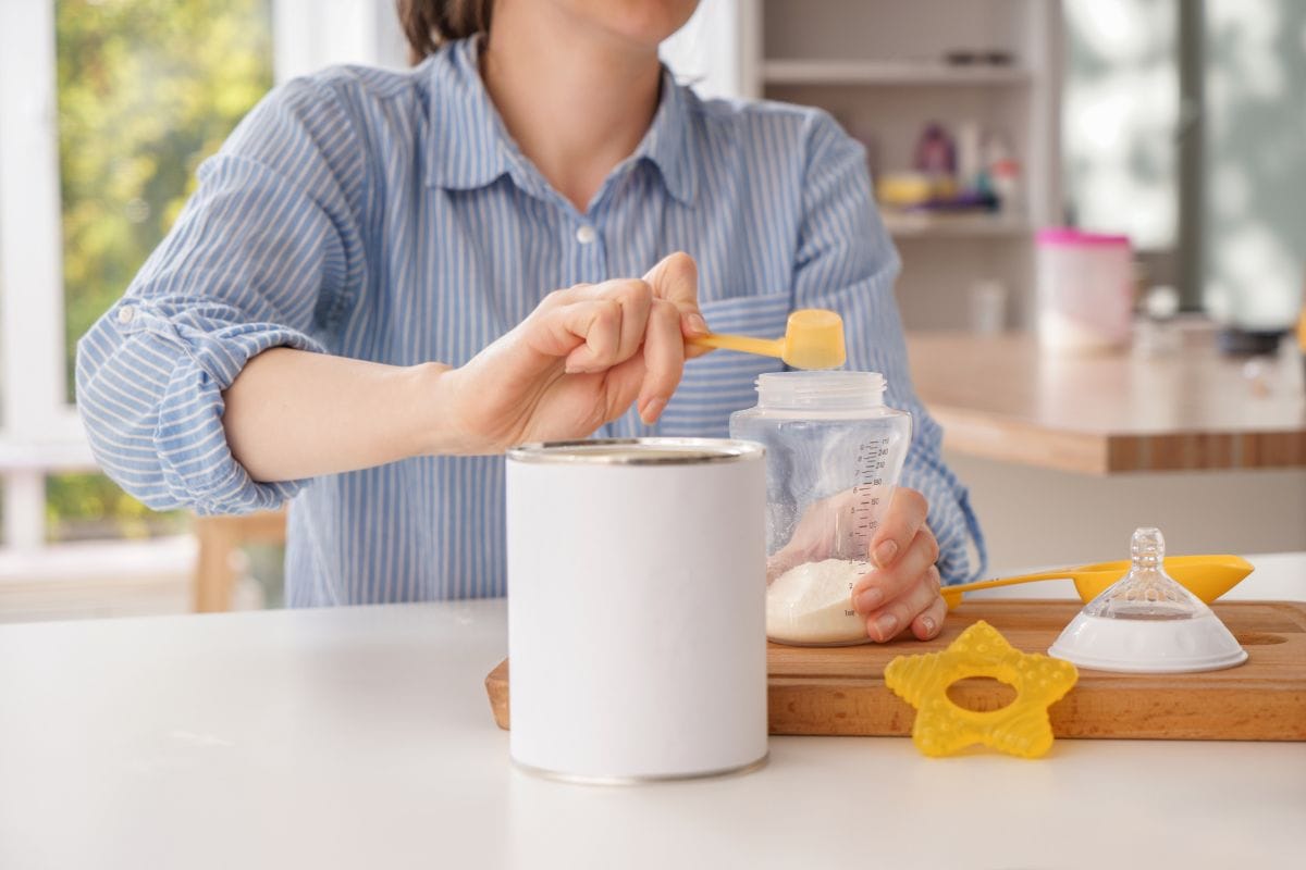 woman preparing baby formula